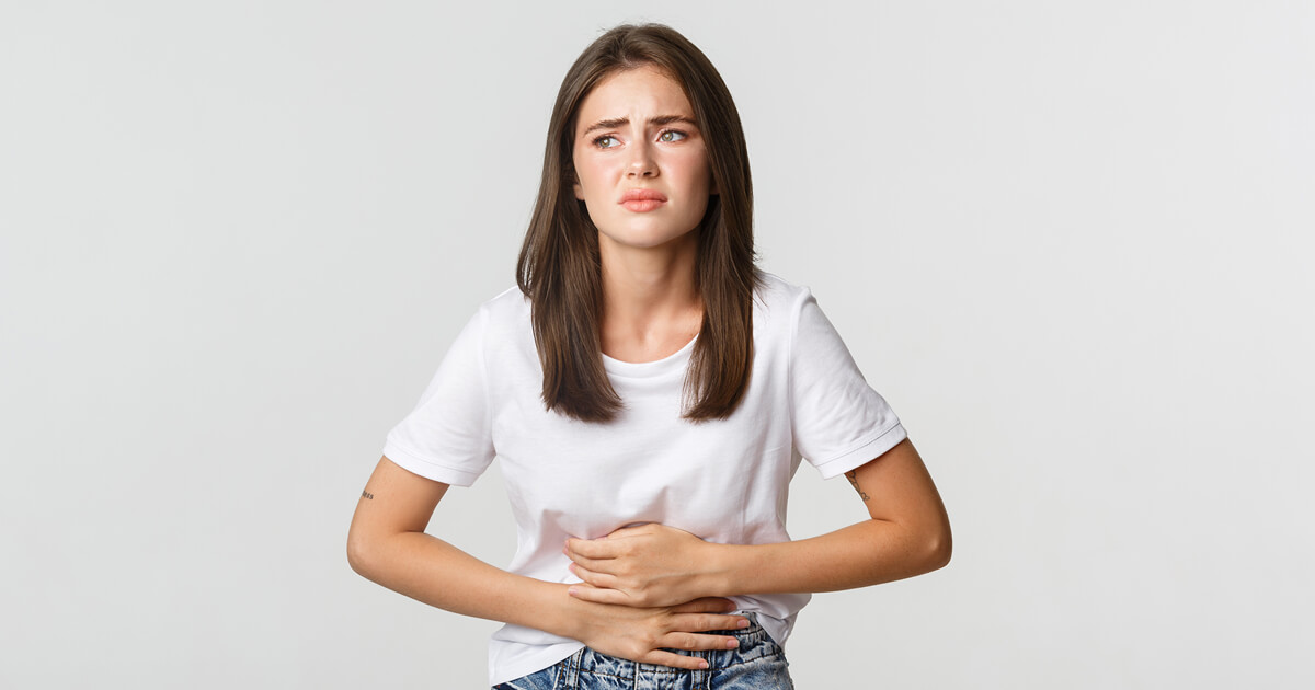Image of a woman holding her stomach