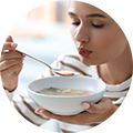 young-woman-eating-tasty-vegetable-soup