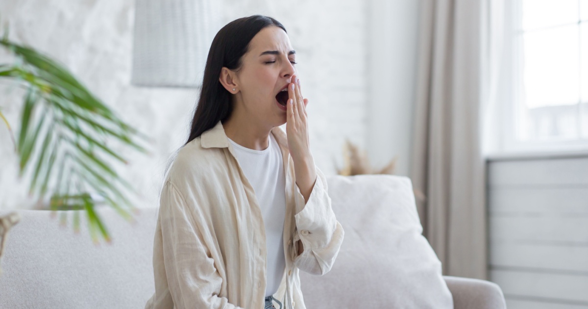 Image of a tired woman yawning.
