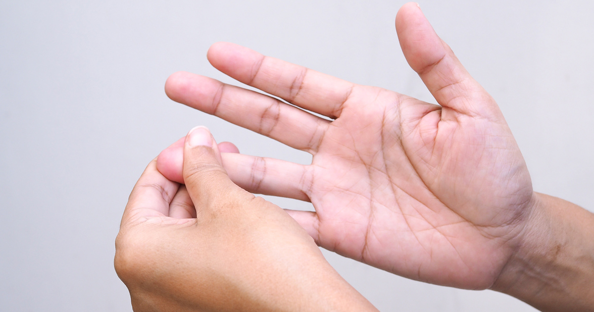 Close up of man holding his fingertips