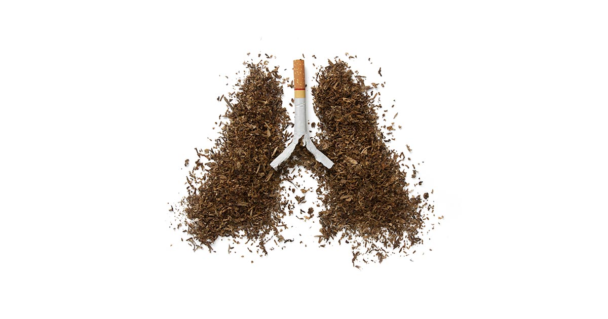 A cigarette and tobacco forming the shape of lungs