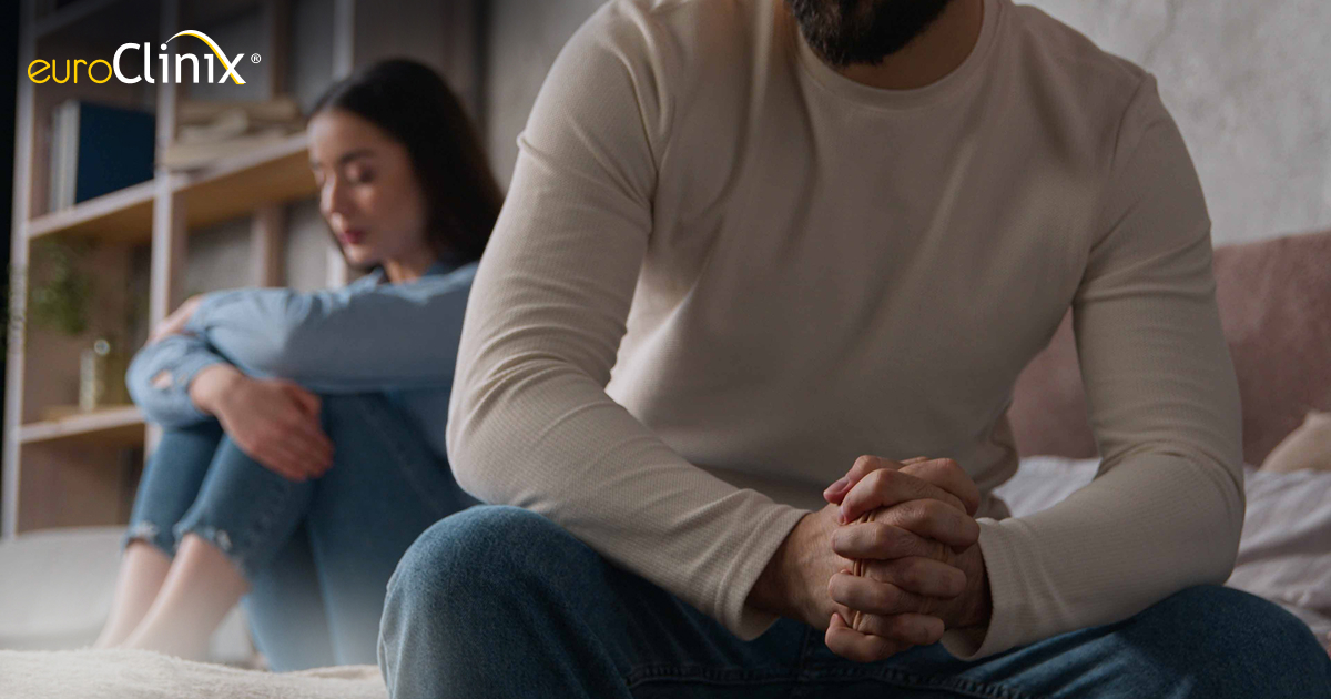 Photo of a couple looking distressed in bed