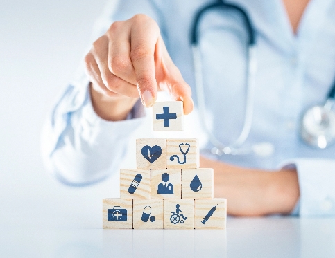 A healthcare professional arranging wooden blocks with medical symbols
