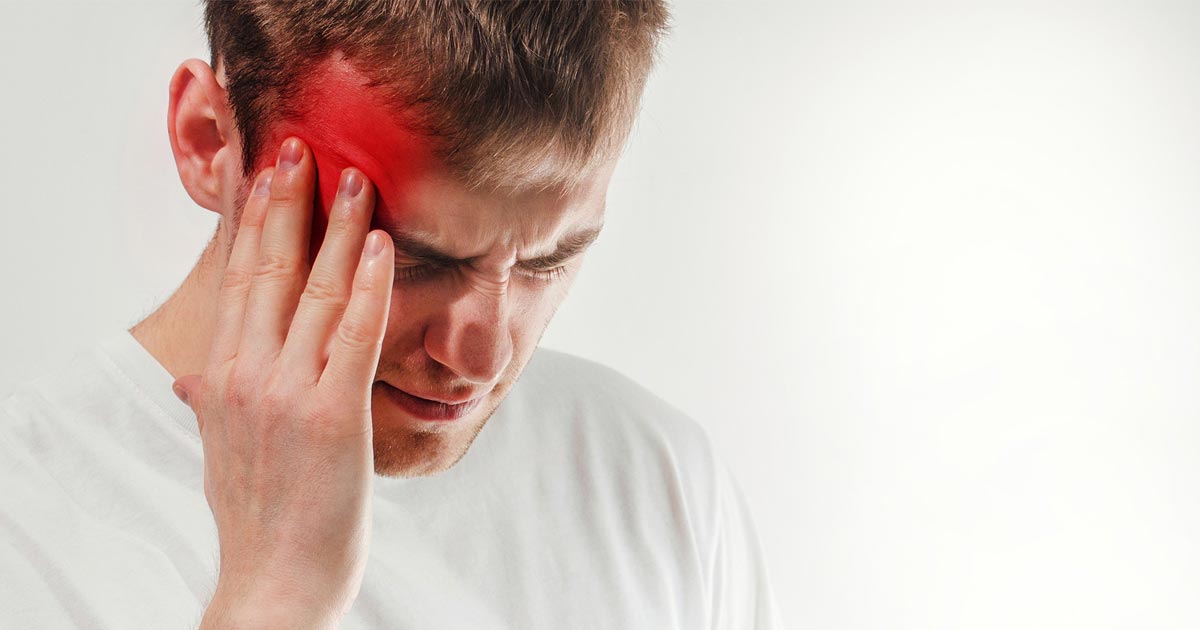 Close up of a man struggling with migraine pain. 