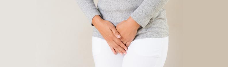 Young woman pressing her crotch lower abdomen. 